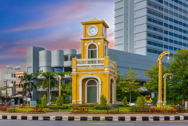 istock Clock tower on a roundabout in old phuket town at during the summer day surrounded by high-rise buildings and Hotels in phuket thailand. 1494038555