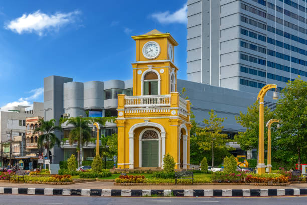 istock Clock tower on a roundabout in old phuket town at during the summer day surrounded by high-rise buildings and Hotels in phuket thailand. 1494038559