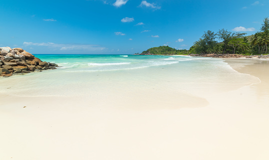 White sand and turquoise water in Anse Kerlan beach. Praslin island, Seychelles