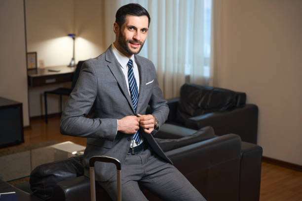 istock Handsome brunette sat down on the back of leather sofa 1494043059
