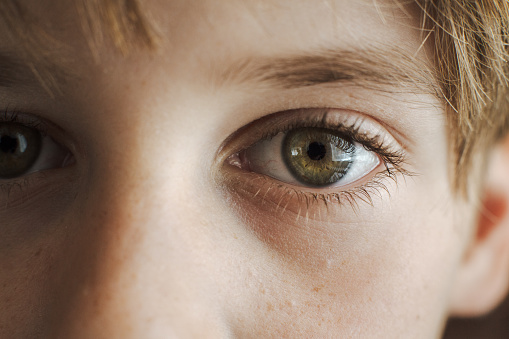 Portrait of a real smiling man looking at camera. Extreme Closeup