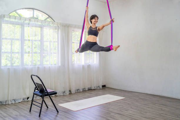 istock Female learning yoga online with a digital tablet 1494052356