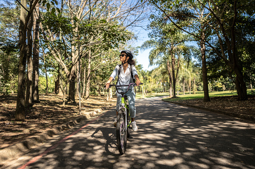 Business woman cycling on the public park