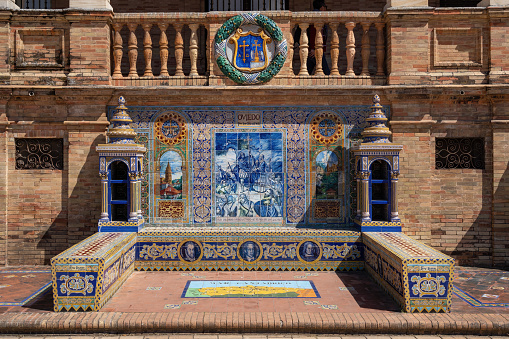 Seville, Spain - Apr 5, 2019: Alcove with bench and tiles representing Oviedo Province - Seville, Andalusia, Spain