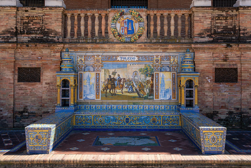 Seville, Spain - Apr 5, 2019: Alcove with bench and tiles representing Toledo Province - Seville, Andalusia, Spain