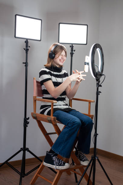 istock Influencer blogger girl making a video with a ring light 1494055267