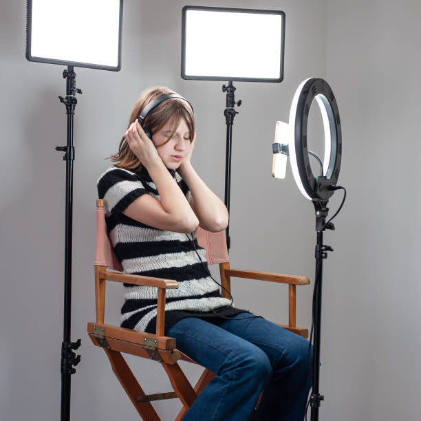 istock Influencer blogger girl making a video with a ring light 1494055304