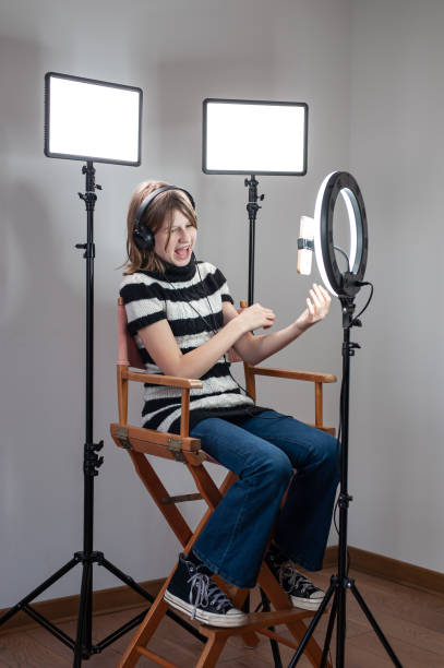 istock Influencer blogger girl making a video with a ring light 1494055408
