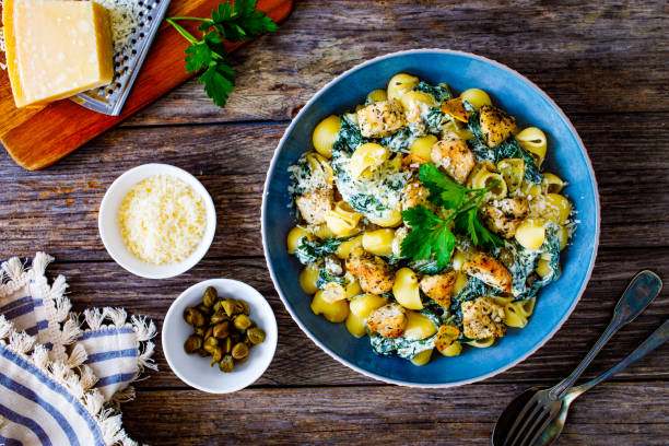 istock Noodles with seared chicken nuggets, spinach and parmesan 1494056387