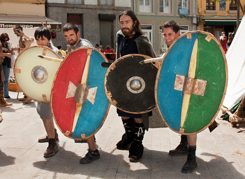 Lugo, Spain_ June 19, 2011: Arde Lucus Historical reenactment, . Street artists disguised with multi colored shields. Lugo city, Galicia, Spain.