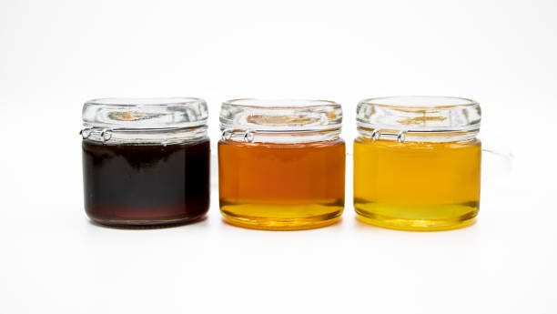 istock Jars with three different types of honey isolated on a white background 1494057159