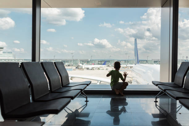istock Excited boy looking at the airplanes arriving on the terminal 1494058995