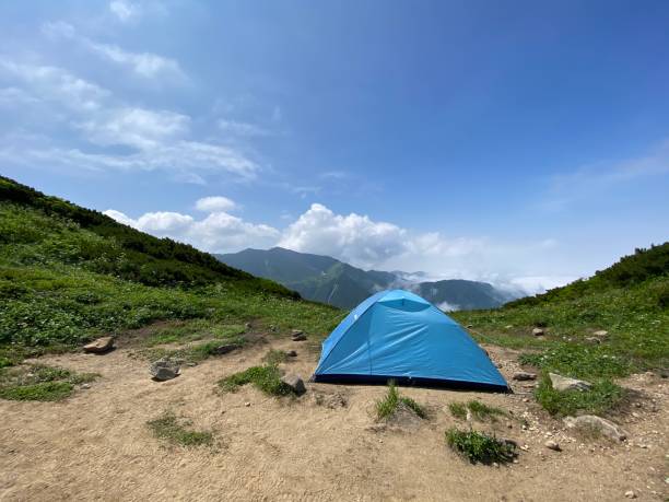A tent pitched on top of a mountain A tent pitched on top of a mountain hidaka mountains stock pictures, royalty-free photos & images