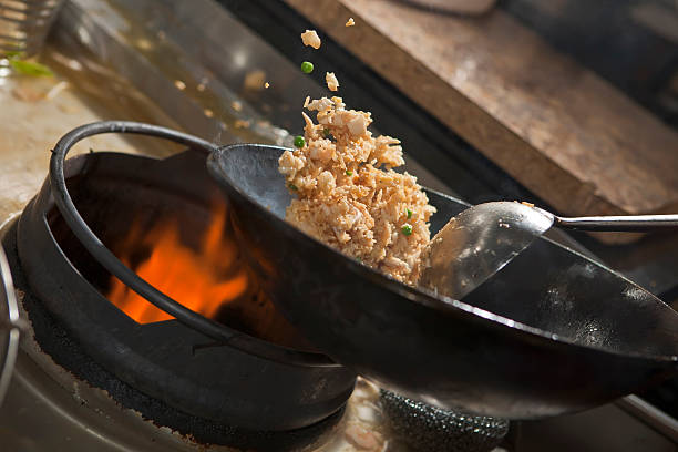 Cooking asian stir fry in wok Closeup of fried rice being cooked in wok chinese cuisine fried rice asian cuisine wok stock pictures, royalty-free photos & images