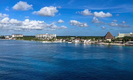 Located about 11 miles off the coast of the Yucatan peninsula and right across Playa del Carmen, Cozumel is the largest island in Mexico and the most popular cruise ship port in the Caribbean. This is a view of the Cozumel shoreline from the deck of our arriving Cruise Ship