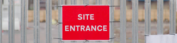 istock Site entrance sign on fence boundary at construction site 1494065285