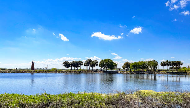 Lakefront Park with a Lighthouse at the end of a jetty and  a great view of Lake Tohopkeliga in Kissimmee, Florida stock photo
