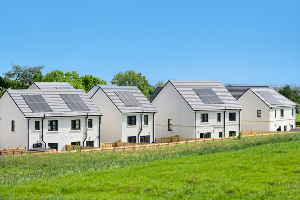 istock Solar panels installed on home roofs at new housing development 1494067902