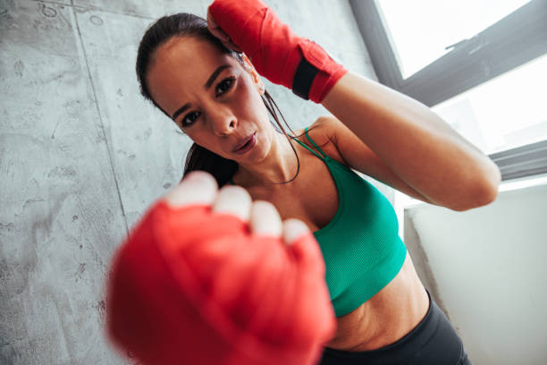 istock Strong woman practicing boxing at gym. 1494068102