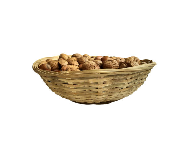 istock Dried nuts in wicker bowl isolated object top view, soft focus clipping path, pistachio, hazelnuts, walnuts, healthy raw food organic diet concept 1494069054