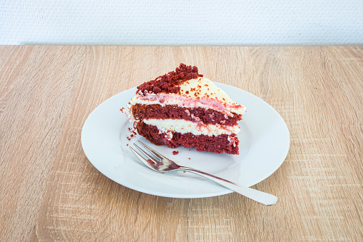 Traditional red, crimson, or scarlet-colored layer cake, layered with ermine icing.