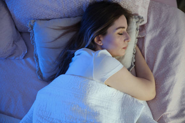 istock Serene beautiful woman sleeping with hand under cheek on pillow 1494076115