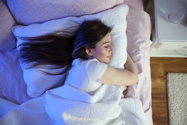istock Serene beautiful woman sleeping with hand under cheek on pillow 1494076146