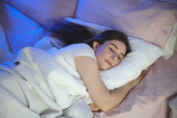 istock Serene beautiful woman sleeping with hand under cheek on pillow 1494076197