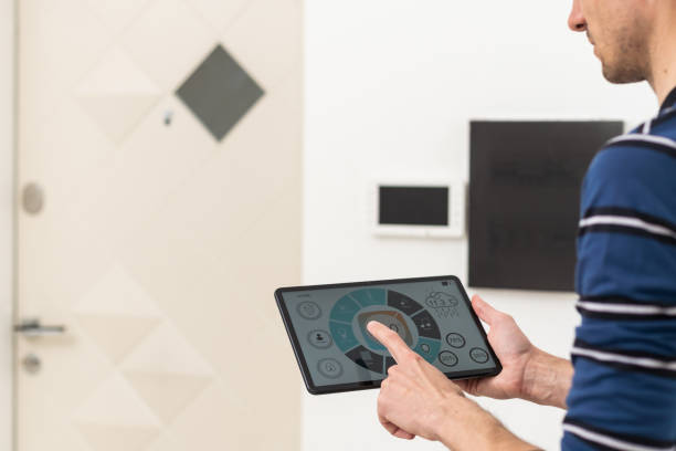 istock an electrician repairs an intercom with a tablet 1494081910