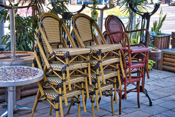 istock Folded tables and chairs in a closed street cafe. 1494082388
