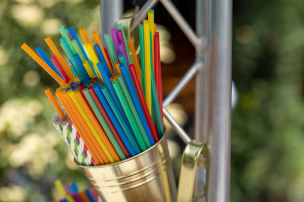 many colorful plastic straws in a jug