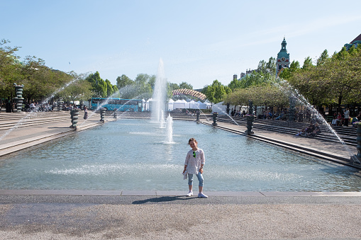 A child walks in the park near the Forumdammen Fountain in Stockholm, Sweden.