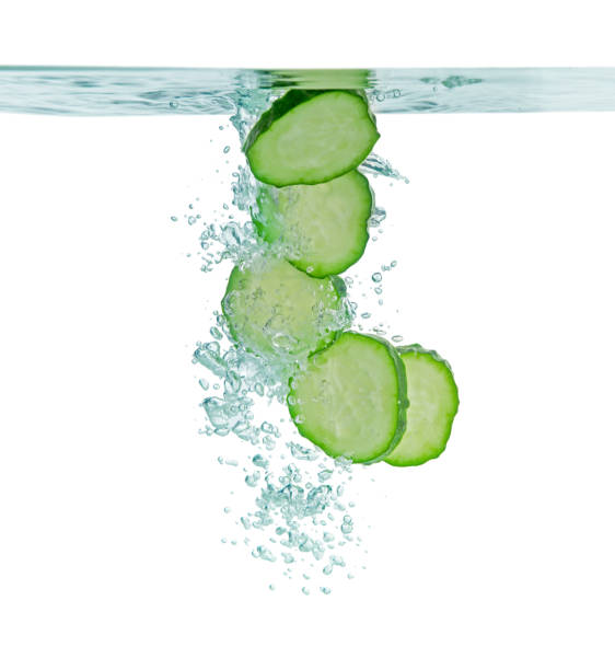 istock Fresh cucumber slices in water on white background 1494089169