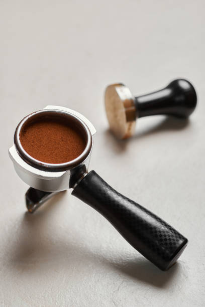 istock A tamper and a Portafilter with fresh ground coffee 1494090272