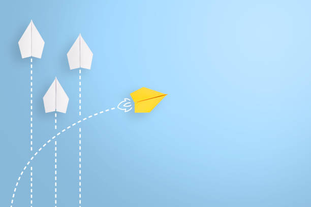 istock Change concepts with yellow paper airplane leading among white 1494094485