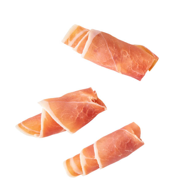 istock Jamon, Prosciutto, Speck, Dry Cured Meat or Ham slice, rolled up isolated on white background. 1494094574