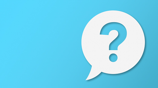 Question Mark and Speech Bubbles with Copy Space On Blue Cardboard Background