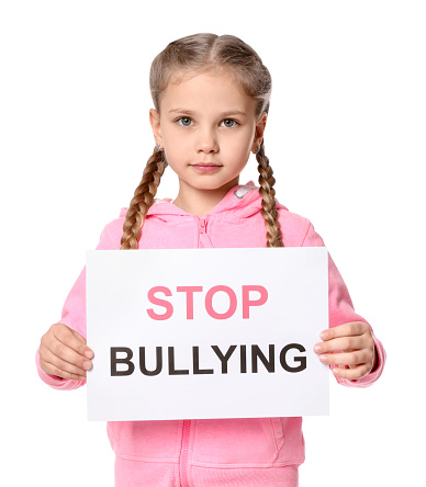Girl holding sign with phrase Stop Bullying on white background
