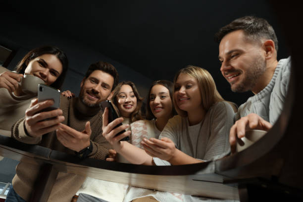 istock Friends with drinks and smartphones spending time together in cafe, low angle view 1494097374