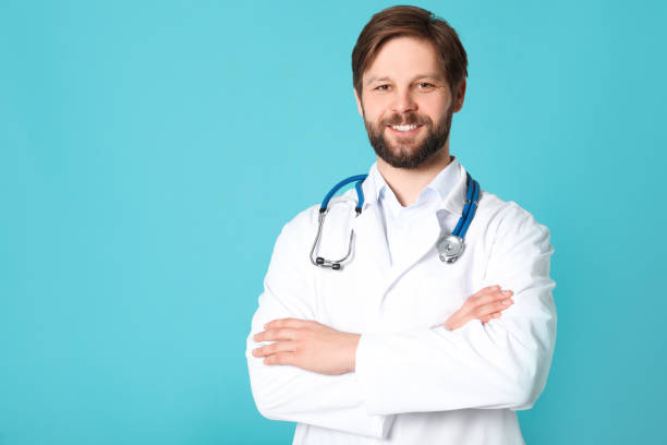 istock Doctor or medical assistant (male nurse) with stethoscope on turquoise background. Space for text 1494097478