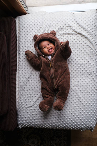 istock African baby with a bear pajama smiling on changing table 1494097603