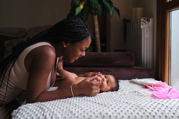 Tender african mother dressing a newborn
