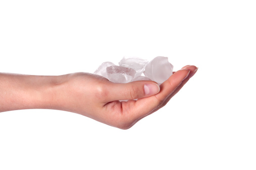 Woman's hands holding ice cubes isolated on a white background