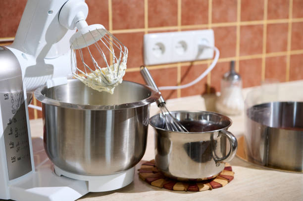 istock Focus on electric modern food processor with planetary mixer with whipped egg whites or whipped cream on kitchen counter 1494100806