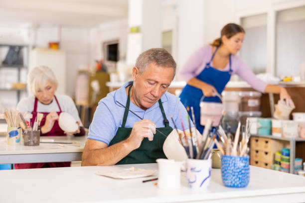 istock man potter carefully paints  vase 1494112475