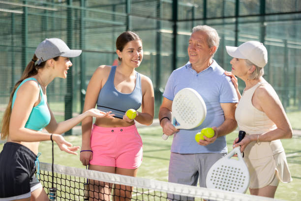 istock Mature husband and wife with their daughters talking before padel game 1494112575