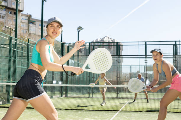 istock Two young motivated female padel players playing together in court 1494112607