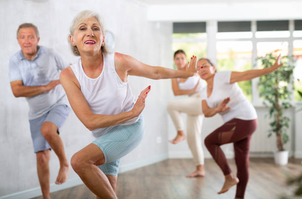 istock Group of elderly people dancing in fitness studio 1494112925