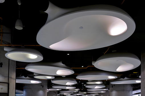 Toronto, Canada - May 13, 2023: New commercial area in Union Station. A series of circular design electric lamps mounted on the ceiling of a building. No people are on the scene.