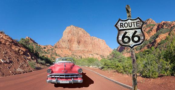 Vintage convertible oldtimer driving through National Park USA on Route 66